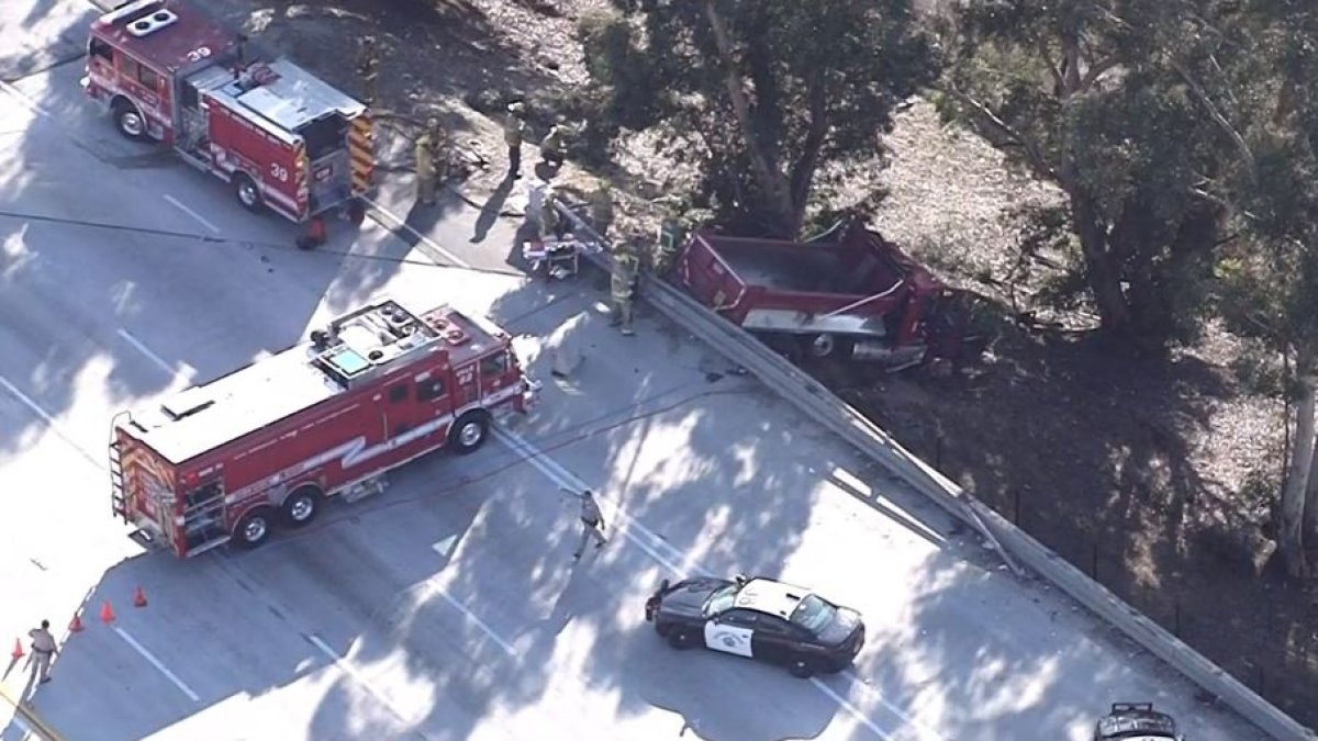 Trapped driver rescued from dump truck in crash off 405 Freeway in Van Nuys Trapped driver rescued from dump truck in crash off 405 Freeway in Van Nuys