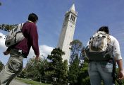 UC Berkeley students walk by Sather Tower on the university campus.