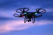 : A drone is flown in the sky.