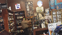 A peafowl perches on top of a shelf at a liquor store Monday June 6, 2017 in Arcadia, California.