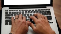 In this June 19, 2017, photo, a person works on a laptop in North Andover, Mass.
