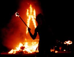 Burning Man Hungrily Eyes Corpse of Dying Newspaper