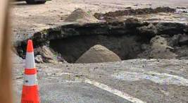 Water Main Rupture Leaves Massive Sinkhole In Van Nuys