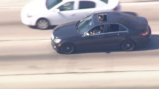 Raw Video: Pursuit Driver Dodges Big Rigs 