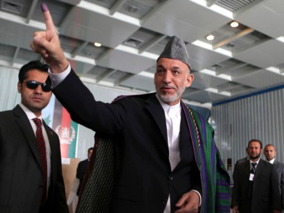 Afghan presidential candidate and current president Hamid Karzai casts his vote. 