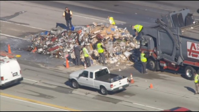 A sanitation truck driver pulled over after the truck's load caught fire near the 405 and 5 freeway interchange in Sylmar. Raw Video from Wednesday, Nov. 21, 2012.