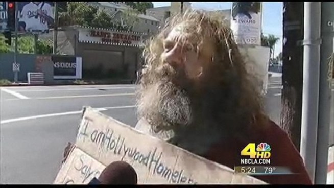Christian Calloway portrays homeless men. On Tuesday, he donated cash at a <a title=