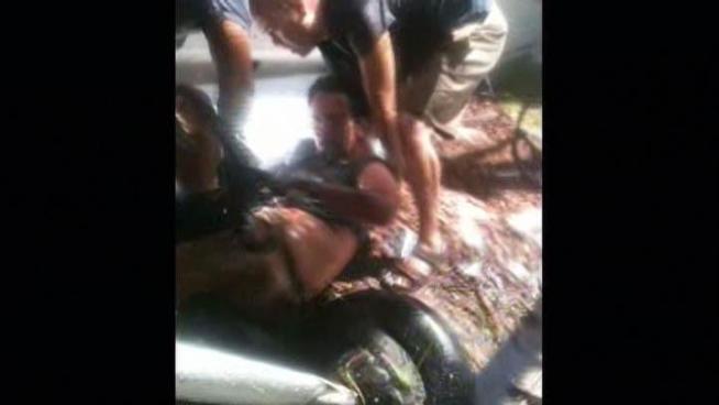 Luis Espana witnessed a pilot being removed from a plane that crashed west of Santa Monica Airport. He captured the rescue on his mobile phone. <a href=