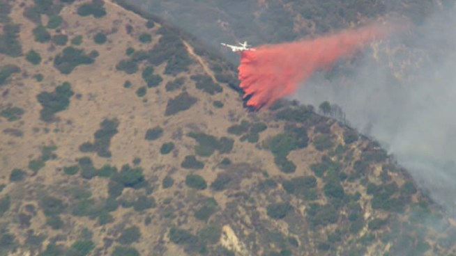 Water-dropping helicopters and fixed-wing aircraft attacked a small brush fire off North San Gabriel Canyon Road in Azusa. Aerial video from Nov. 13, 2012.