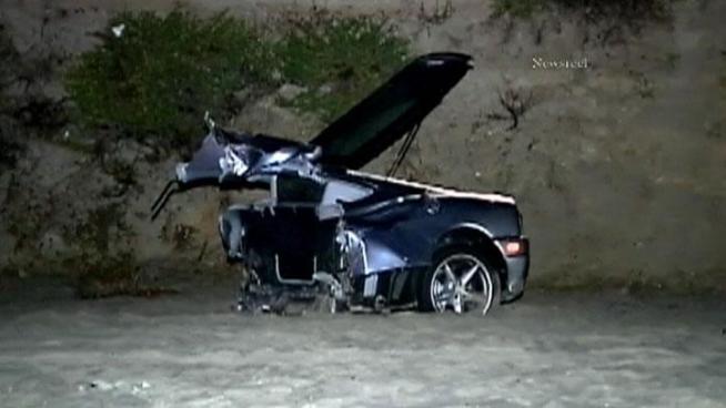 A Ferrari was cut in half when it hit a power pole along Pacific Coast Highway and crashed onto a Pacific Palisades beach Sunday, killing one man and critically injuring another.
