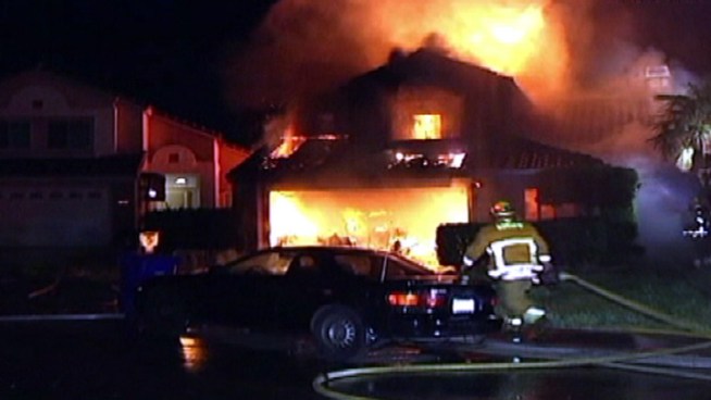 An explosion blew a garage door of the home across the street.