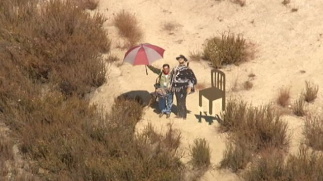 In a nod to Clint Eastwood's unusual speech at the 2012 Republican National Convention, two empty chairs have been placed next to a Glendale hillside public art installation that's a cut-out of the iconic film actor. When NewsChopper 4 flew over the hill to get a closer look Tuesday, a local newspaper photographer there snapping pictures got in on the action: He took President Barack Obama's seat. Raul Roa, a photographer for the Los Angeles Times Community News division, <a href=