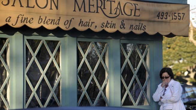 Flowers and other items are placed outside Salon Meritage, site of Wednesday's deadly shooting.