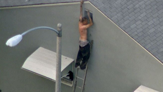 A man who allegedly stole a vehicle and then fled on foot from pursuing LA County Sheriff's Department deputies entered a home in Lakewood. Authorities then appeared to fire tear gas into the home, and the man fled into the attic, breaking through a vent for fresh air. He eventually was helped down a ladder and taken into custody. Raw video from NewsChopper 4 with Alex Calder reporting on Jan. 24, 2013.