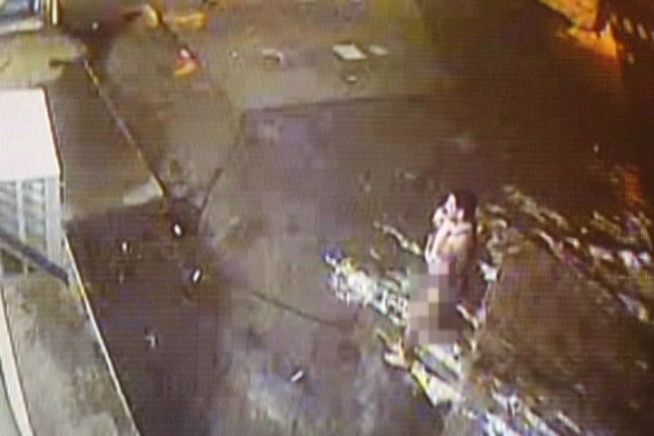 A man is caught on surveillance video, running through the streets of Bridgeport, carrying a baby.