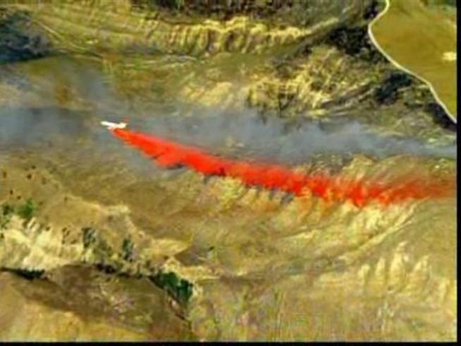 A DC-10 tanker drops flame retardant in the Guiberson Fire burn area.