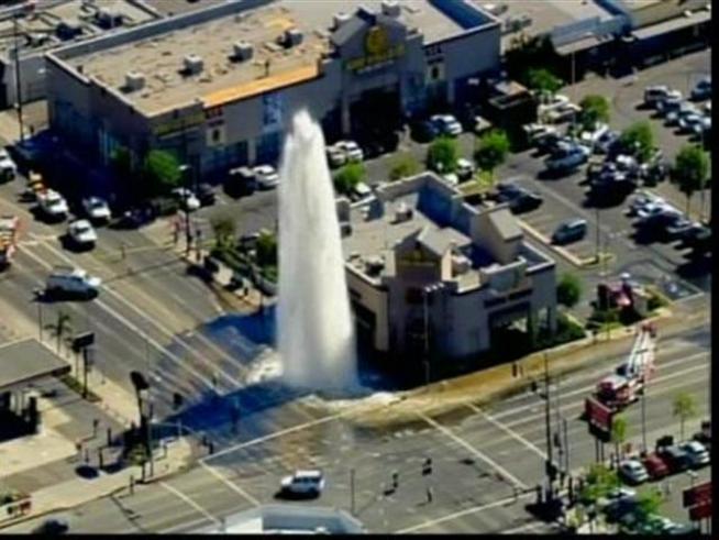 Look out below -- a broken water main sends a tower of water above Van Nuys.