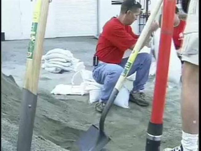 Volunteers fill sandbags in advance of storms.