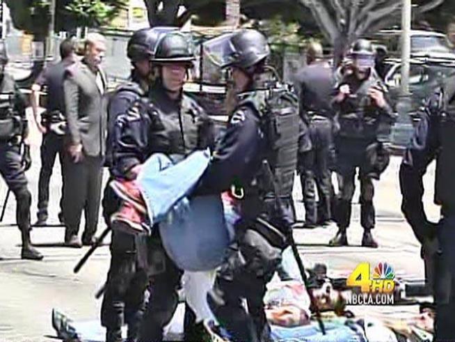 Ten people chained themselves together and hundreds of others marched around them Thursday as part of a protest of <a title=