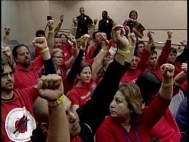 Protesters raise their fists in a gesture on unity.