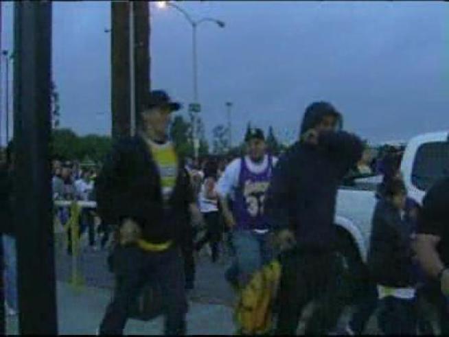 Gates open just after dawn Wednesday to accommodate fans lined up for the Lakers celebration.