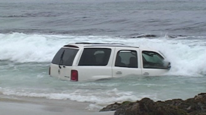 Someone, somehow drove a Cadillac Escalade into the ocean at Pebble Beach. Tow trucks were able to drag the Escalade out of the water within an hour. Raw video.
