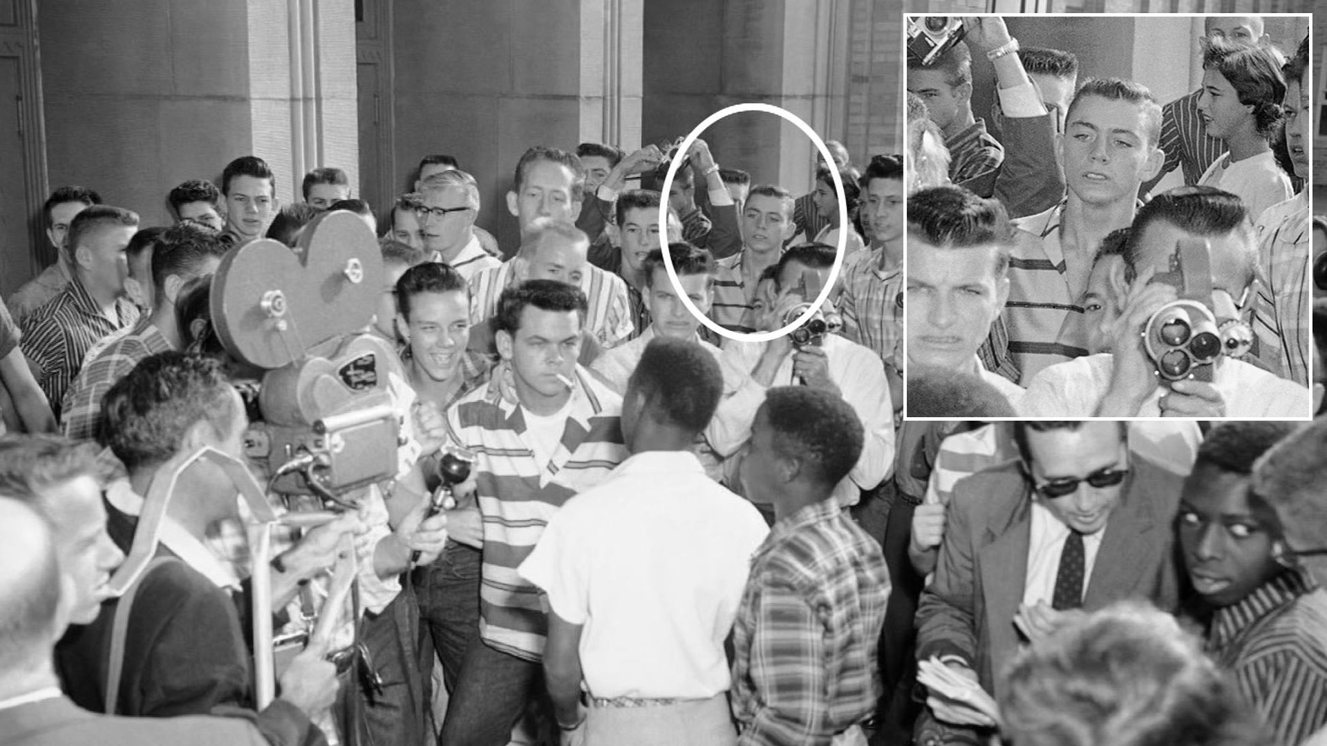 A Sept. 9, 1957, AP Photo shows Dallas Cowboys owner Jerry Jones in the background of a group of defiant white students at Arkansas' North Little Rock High School blocking the doors of the school, denying access to six African-American students enrolled in the school. Moments later the African American students were shoved down a flight of stairs and onto the sidewalk, where city police broke up the altercation.