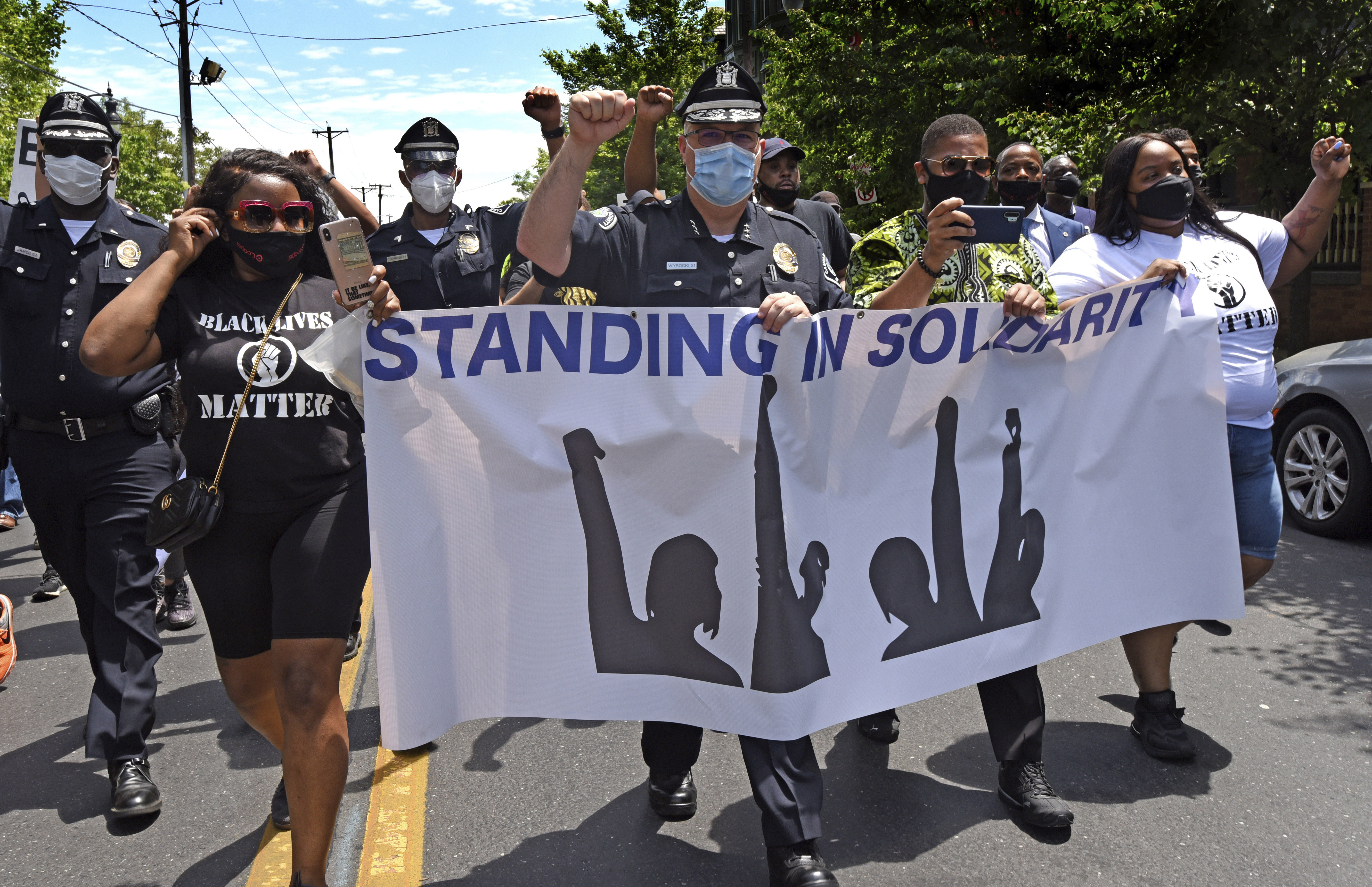 In this Saturday, May 30, 2020, photo, Camden County Metro Police Chief Joe Wysocki raises a fist while marching with Camden residents and activists in Camden, N.J., to protest the death of George Floyd in Minneapolis.