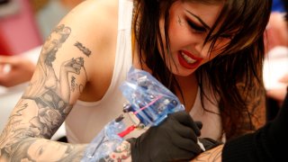 Kat Von D inks tattoo on client