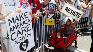 People rally at the Families Belong Together - Freedom for Immigrants March in downtown Los Angeles on June 30, 2018.