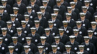 In this Dec. 14, 2019 file photo, Navy midshipmen march onto field ahead of an NCAA college football game between the Army and the Navy in Philadelphia.