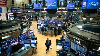 In this Friday, March 13, 2020, file photo, a trader walks on the floor of the New York Stock Exchange during President Donald Trump's televised speech from the White House, in New York.