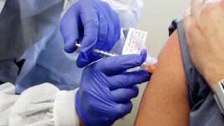 In this March 16, 2020, file photo, Neal Browning receives a shot in the first-stage safety study clinical trial of a potential vaccine for COVID-19, the disease caused by the new coronavirus at the Kaiser Permanente Washington Health Research Institute in Seattle.