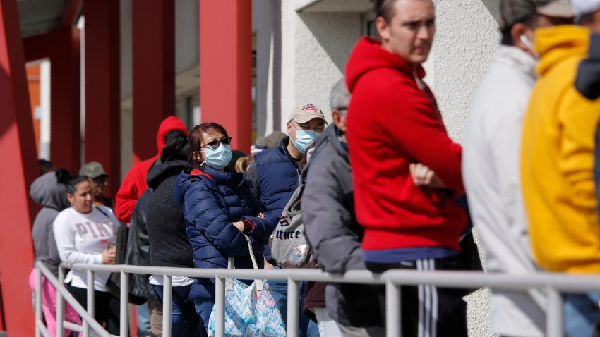People wait in line for help with unemployment benefits at the One-Stop Career Center, Tuesday, March 17, 2020, in Las Vegas. Nevada Department of Employment, Training and Rehabilitation and its partner organizations, like the One-Stop Career Center, have seen an increase in traffic due to the coronavirus.