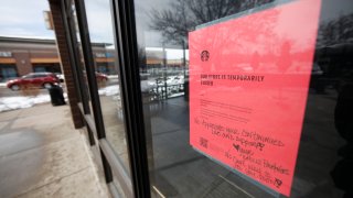 A sign tells customers that Starbucks cafe is closed temporarily as residents deal with the spread of coronavirus Saturday, March 21, 2020, in Denver.