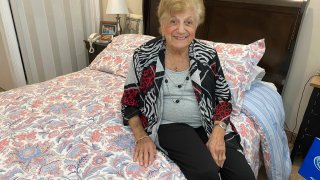COVID-19 survivor Anna Fortunato poses for a portrait in her room at The Arbors assisted living community in Jericho, N.Y. on Tuesday, March 31, 2020. Fortunato, 90, says people should keep fighting the new coronavirus and that, "If I did it, you can do it."