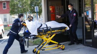 Medical workers bring a patient to the Northbridge Health Care Center