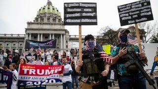 n this April 20, 2020, file photo protesters demonstrate at the state Capitol in Harrisburg, Pa., demanding that Gov. Tom Wolf reopen Pennsylvania's economy even as new social-distancing mandates took effect at stores and other commercial buildings.