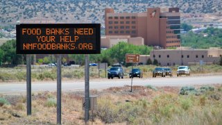 This May 7, 2020, image shows an electronic highway message board in Rio Rancho, New Mexico, that encourages people to donate to food banks.