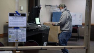 Voter places ballot in the counter machine