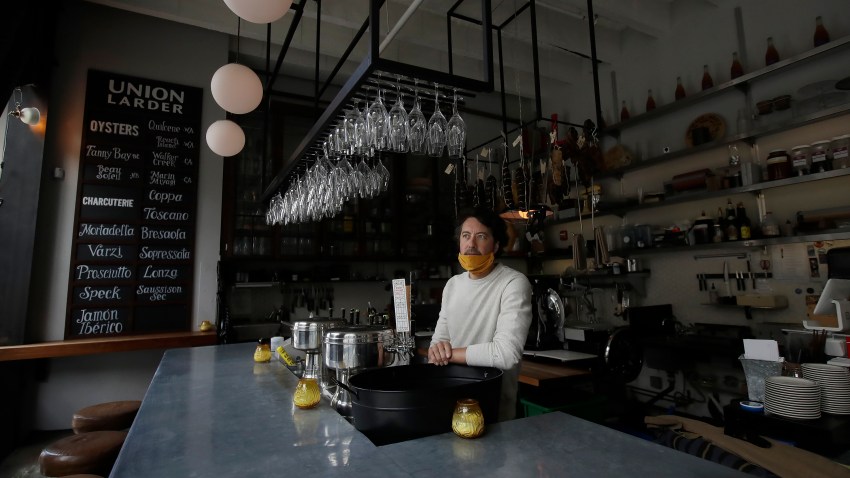 Jay Esopenko, owner of the cheese, wine and charcuterie bar Union Larder, wears a face mask while interviewed during the coronavirus outbreak in San Francisco, Tuesday, May 12, 2020.