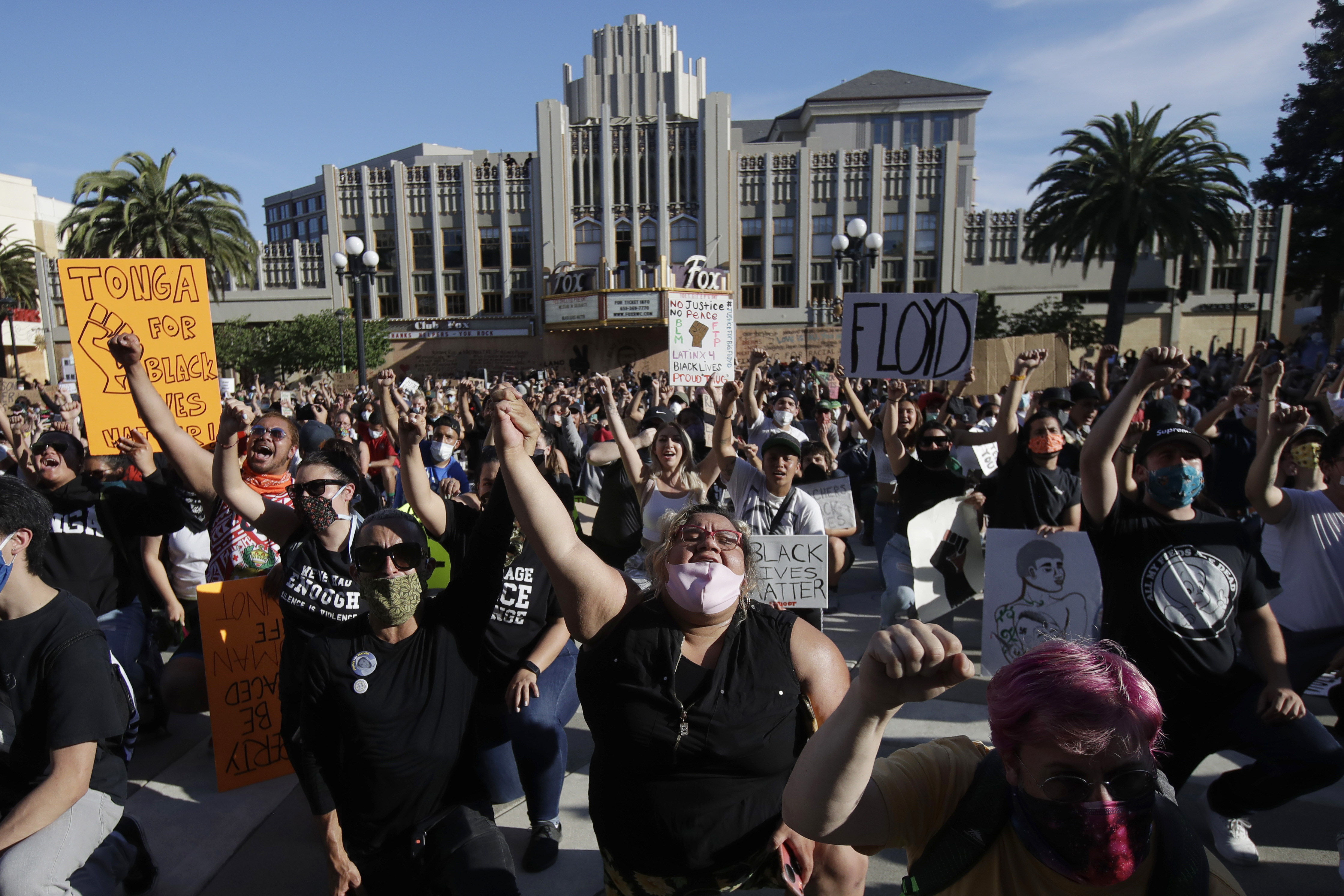 Demonstrators kneel in Redwood City, California, June 2, 2020, at a protest over the death of George Floyd, who died in Minneapolis after being restrained by police.