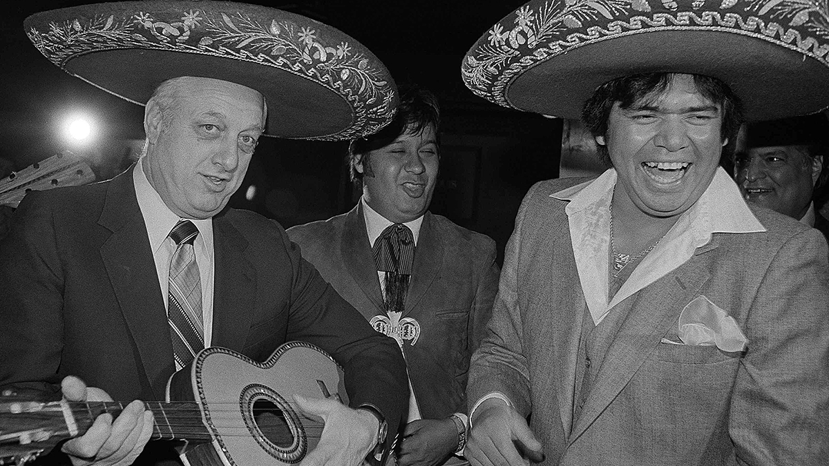 Los Angeles Dodgers’ Manager Tommy Lasorda strums a new song… to the tune of El Novato del Ano … or Rookie of the Year for his ace pitcher Fernando Valenzuela, who received the 1981 National League title in Los Angeles Wednesday, Dec. 3, 1981. The 21-year-old southpaw was also the recipient of this year’s Cy Young Award. (AP Photo/Wally Fong)