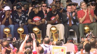 In this June 16, 1998, file photo, NBA Champions (from left) Ron Harper, Dennis Rodman, Scottie Pippen, Michael Jordan and coach Phil Jackson are joined on stage by Chicago Mayor Richard Daley, second from right, during a city-wide rally in Chicago, Ill.