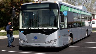 In this May 1, 2013, file photo, an electric bus produced by China's BYD Co., is parked at the announcement of the opening of an electric bus manufacturing plant in Lancaster, Calif. The Chinese automaker that sold more electric cars last year than Tesla, Nissan and GM combined is taking a back road into the American market on a battery-powered bus.