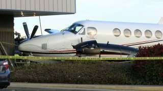 A plane, stolen by a 17-year-old girl, crashes into a building at Fresno Yosemite International Airport on Dec. 18, 2019, in Fresno, California.