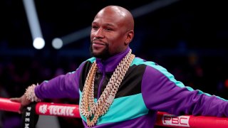 Floyd Mayweather Jr. stands in the ring before Errol Spence Jr takes on Mikey Garcia in an IBF World Welterweight Championship bout at AT&T Stadium on March 16, 2019, in Arlington, Texas.