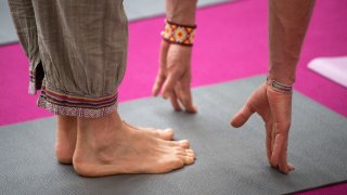 26 April 2019, Baden-Wuerttemberg, Stuttgart: A man does an exercise at the yoga mass. Photo: Sebastian Gollnow/dpa (Photo by Sebastian Gollnow/picture alliance via Getty Images)