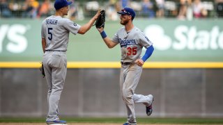 Corey Seager #5 and Cody Bellinger #35 of the Los Angeles Dodgers agree to contracts, avoiding arbitration.