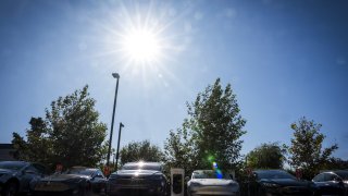 The sun shines above a Tesla charging station in Concord, California.